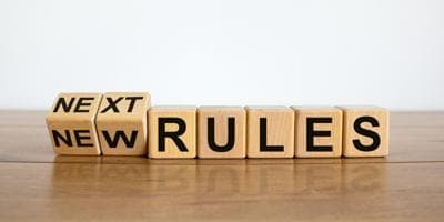 blocks of wood with letters that spell new rules