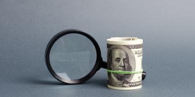 magnifying glass and cash