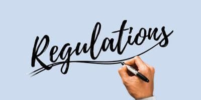 a hand writing the word regulations